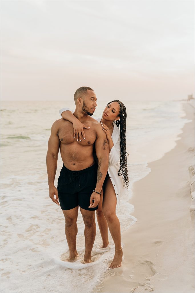 woman embracing man on beach