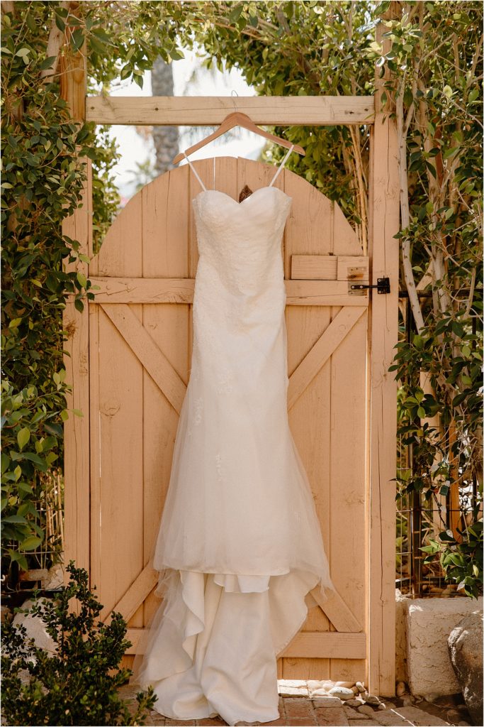 Wedding dress hanging at backyard palm springs wedding venue