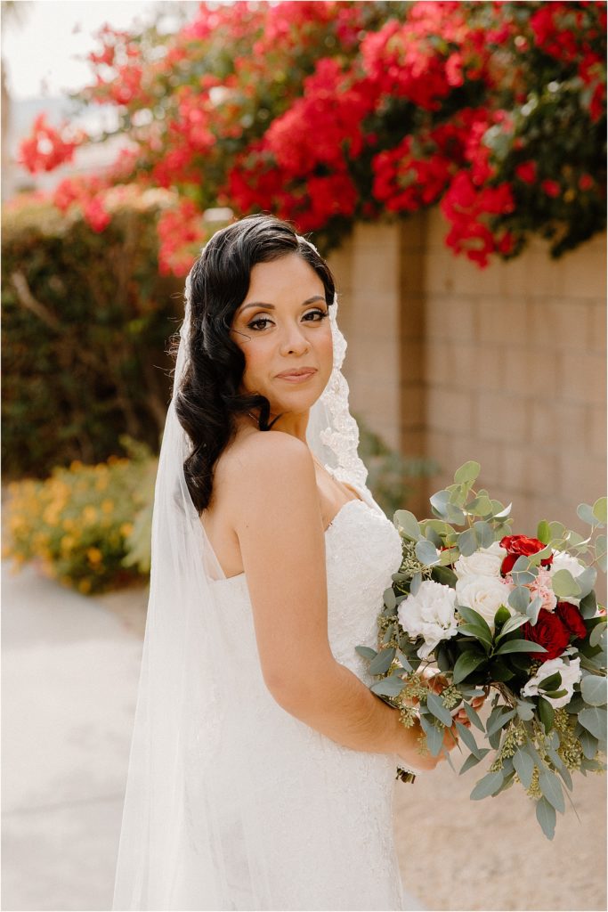 bride with spanish cathedral veil at backyard palm springs wedding venue